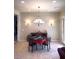 Cozy dining area with a poker table and sideboard, lit by sconces and a chandelier at 18391 W Verdin Rd, Goodyear, AZ 85338