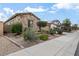 Beautiful home with stone facade, desert landscaping and a well-manicured front yard at 18391 W Verdin Rd, Goodyear, AZ 85338