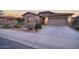Charming stone-accented home features a well-maintained yard and a two-car garage at 18391 W Verdin Rd, Goodyear, AZ 85338