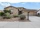 Stunning stone front home with a wide driveway and attractive desert landscaping at 18391 W Verdin Rd, Goodyear, AZ 85338