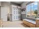 Hallway includes storage bench, closet, and views of desert landscape through window at 18391 W Verdin Rd, Goodyear, AZ 85338