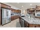 Spacious kitchen featuring granite countertops, stainless steel appliances, and ample cabinet space at 18391 W Verdin Rd, Goodyear, AZ 85338