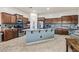 Open kitchen with a large center island, stainless steel appliances, and custom cabinetry at 18391 W Verdin Rd, Goodyear, AZ 85338