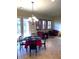 Living room with poker table, red sofa and lounger, and decorative wall details at 18391 W Verdin Rd, Goodyear, AZ 85338