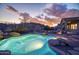 Inviting backyard pool featuring rock accents, desert landscape, and mountain views at 18391 W Verdin Rd, Goodyear, AZ 85338