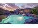 Backyard features a refreshing pool, desert landscaping, mountain views, and covered patio at 18391 W Verdin Rd, Goodyear, AZ 85338