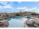 Backyard features sparkling rock-lined pool and desert views at 18391 W Verdin Rd, Goodyear, AZ 85338