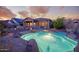 Relaxing backyard oasis with pool, desert landscaping, and covered patio at 18391 W Verdin Rd, Goodyear, AZ 85338