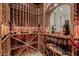 Well-appointed wine cellar with custom wooden racks and ample space for wine storage at 18391 W Verdin Rd, Goodyear, AZ 85338