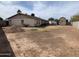 Large backyard featuring a home, storage shed, and barren land at 1858 N Hibbert Cir, Mesa, AZ 85201