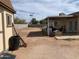 View of the backyard featuring a shed, patio, and an expanse of arid land at 1858 N Hibbert Cir, Mesa, AZ 85201