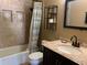 Bathroom showcasing a shower-tub combo with decorative tile and a granite-topped vanity at 1858 N Hibbert Cir, Mesa, AZ 85201