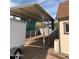 Exterior shot of covered carport near a barn-style shed, featuring a white trailer at 1858 N Hibbert Cir, Mesa, AZ 85201