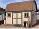 Exterior of shed featuring a barn roof, double doors, and two small windows at 1858 N Hibbert Cir, Mesa, AZ 85201