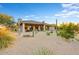 Home's backyard features a covered patio and low-maintenance desert landscaping at 18820 E Gemmill Dr, Rio Verde, AZ 85263