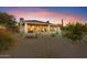 Rear of the home with covered patio, desert landscaping, and mature native cacti at 18820 E Gemmill Dr, Rio Verde, AZ 85263