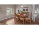 Dining room with wooden table and chairs, wood floors, and views of the kitchen through an opening at 19225 N 31St Dr, Phoenix, AZ 85027