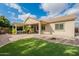 Inviting backyard featuring a covered patio, pergola, and lush green lawn for outdoor enjoyment at 19257 E Canary Way, Queen Creek, AZ 85142