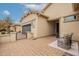 Charming home exterior with a paver driveway, gated entrance, and attached garage at 19257 E Canary Way, Queen Creek, AZ 85142