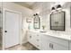 Bathroom featuring double sinks with white cabinets and a glass enclosed shower at 2043 E Clipper Ln, Gilbert, AZ 85234