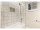 Clean bathroom with a tiled shower, built-in shelf, and modern fixtures at 2043 E Clipper Ln, Gilbert, AZ 85234