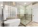 Bright bathroom featuring a modern tub, glass-enclosed shower, and stylish tile work at 2043 E Clipper Ln, Gilbert, AZ 85234