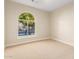 Cozy bedroom featuring an arched window, neutral walls, and plush carpeting at 2043 E Clipper Ln, Gilbert, AZ 85234