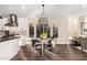 Modern dining area adjacent to kitchen features views from window and industrial style chandelier at 2043 E Clipper Ln, Gilbert, AZ 85234