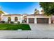Charming home showcasing its lush lawn, arched windows, and a convenient three-car garage at 2043 E Clipper Ln, Gilbert, AZ 85234