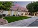 Charming single-story home with a well-manicured lawn and a spacious three-car garage at 2043 E Clipper Ln, Gilbert, AZ 85234