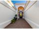 Inviting entryway with brick pavers, decorative plants, and a stylish black front door at 2043 E Clipper Ln, Gilbert, AZ 85234
