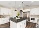 Modern kitchen with stainless steel appliances, a large kitchen island, and white cabinetry at 2043 E Clipper Ln, Gilbert, AZ 85234