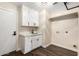 Laundry room with white cabinets, white counter tops, and modern fixtures at 2043 E Clipper Ln, Gilbert, AZ 85234