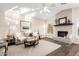 Bright living room featuring a fireplace, hardwood floors, neutral colors, and ample natural light at 2043 E Clipper Ln, Gilbert, AZ 85234