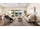 Bright living room showcasing elegant sofas, stylish rug, and a view of the backyard and waterfront at 2043 E Clipper Ln, Gilbert, AZ 85234