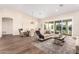 Cozy living room and dining room combo, with views of the outdoors, wood flooring, and recessed lighting at 2043 E Clipper Ln, Gilbert, AZ 85234