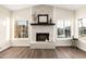 Beautiful living room featuring fireplace and an open view to a waterfront with bright, natural light from surrounding windows at 2043 E Clipper Ln, Gilbert, AZ 85234