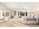 Bright main bedroom with a ceiling fan, bay window, and access to an outdoor area at 2043 E Clipper Ln, Gilbert, AZ 85234