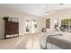 A spacious main bedroom with a ceiling fan, walk out doors and lake view at 2043 E Clipper Ln, Gilbert, AZ 85234