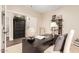 Well-appointed home office with a desk, shelving, and adjacent room with wood floors at 2043 E Clipper Ln, Gilbert, AZ 85234