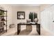 Home office features a desk, shelving, and natural light with carpeting at 2043 E Clipper Ln, Gilbert, AZ 85234