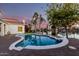 Inviting backyard pool with brick patio, lake view, and mature landscaping at 2043 E Clipper Ln, Gilbert, AZ 85234