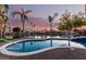 Backyard swimming pool offering a relaxing view of the adjacent lake and surrounding properties at 2043 E Clipper Ln, Gilbert, AZ 85234