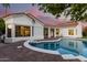 Backyard pool with a connecting spa with brick pavers surrounded by a white stucco home exterior at 2043 E Clipper Ln, Gilbert, AZ 85234