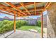 Cozy back patio with brick pavers, wood pergola, artificial turf, and lush landscaping at 2133 W Gold Dust Ave, San Tan Valley, AZ 85144