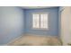 This blue bedroom features a window with blinds and a closet with a door at 2133 W Gold Dust Ave, San Tan Valley, AZ 85144