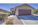 Exterior view of a single-story home featuring a concrete driveway and desert landscaping at 2133 W Gold Dust Ave, San Tan Valley, AZ 85144