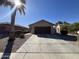 A single-story home with a concrete driveway, desert landscaping, and a dark brown garage door at 2133 W Gold Dust Ave, San Tan Valley, AZ 85144