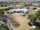 Expansive aerial view of white adobe home, pool and desert landscaping in sunny climate at 22236 E Nacoma --, Queen Creek, AZ 85142