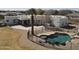 Aerial view of the property showcases the pool with slide, and outdoor firepit with desert landscape at 22236 E Nacoma --, Queen Creek, AZ 85142